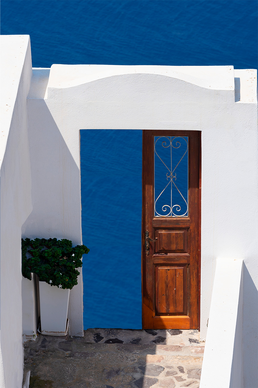 This is a photo of an open wooden door that leads to water in Greece that represents the positive affects.